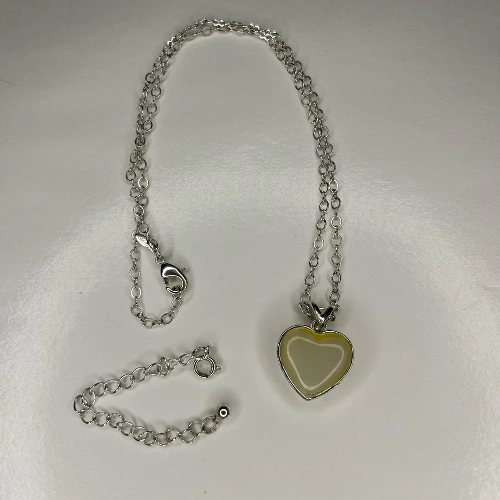 Avon silver heart dainty with cream stone pendant.